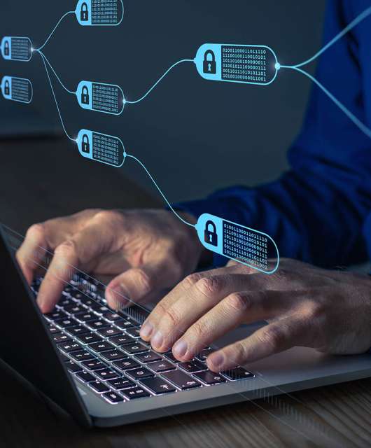 Image of hands typing on a laptop leyboard